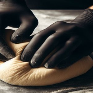 Baker With Gloved Hands Working on Dough